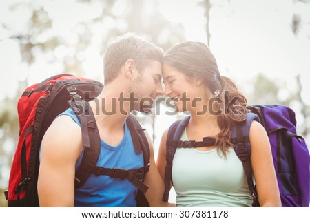 Young happy joggers touching foreheads in the nature