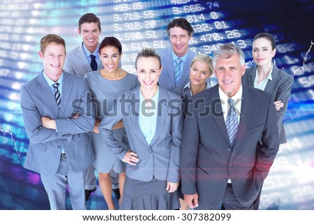 Smiling business people smiling at camera against stocks and shares