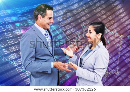 Confident business people smiling against stocks and shares