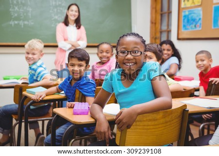Students and teacher looking at the camera at the elementary school