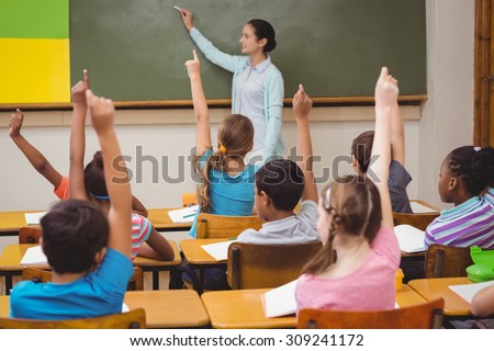 Teacher asking a question to her class at the elementary school