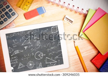 Math equations against students desk with tablet pc