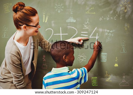 School subjects doodles against teacher assisting boy to write on blackboard in classroom