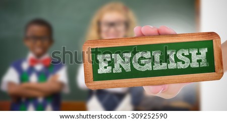 The word english and hand showing chalkboard against pupils smiling at camera with arms crossed