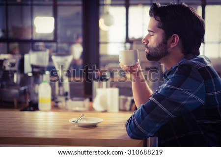 Worried man drinking a coffee at the cafe