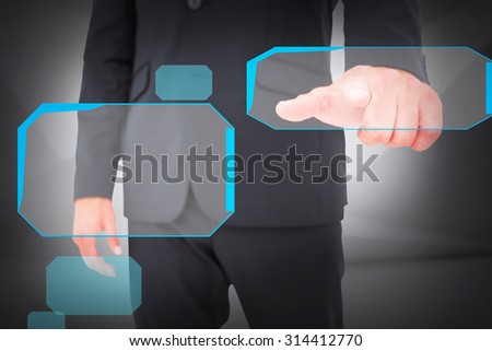 Businessman pointing with finger against abstract white room