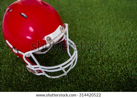 Upward view of an american football helmet on the field