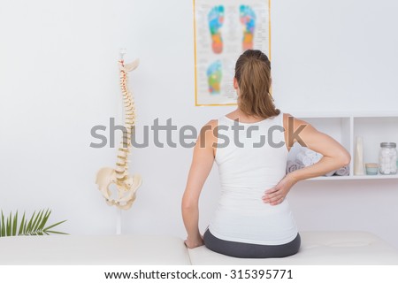 Wear view of patient with back pain in medical office