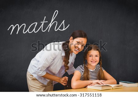 The word maths and female teacher and little girl in library against blackboard