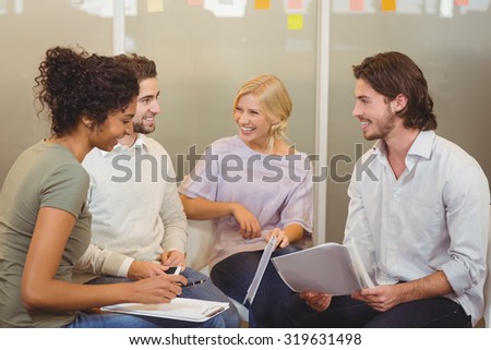 Colleagues interacting with each other in meeting at creative office