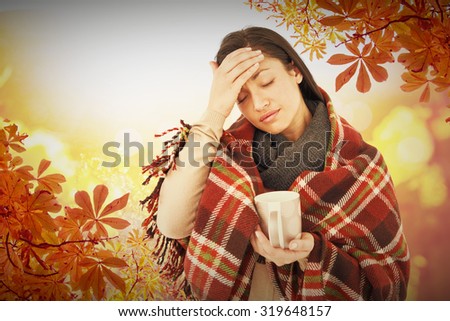 Sick woman having a migraine against autumn scene