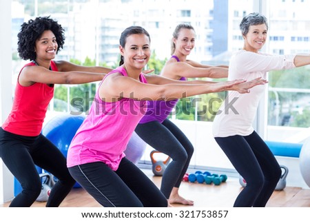 Portrait of smiling women exercising in fitness studio