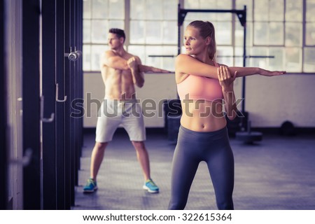 two fit people doing fitness in crossfit gym