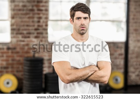 Portrait of muscular man looking at camera in crossfit gym