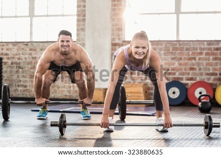 Two fit people working out at session