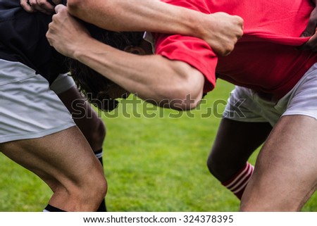 Rugby players doing a scrum at the park