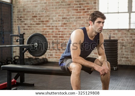 Man sitting on the bench at gym