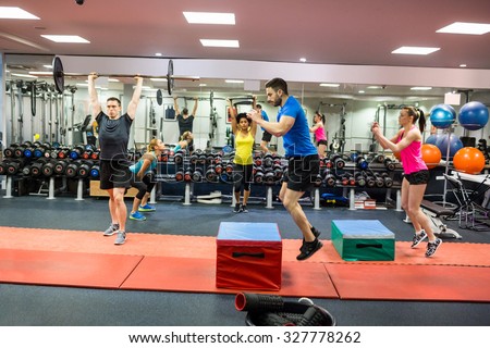 Fit people working out in weights room at the gym