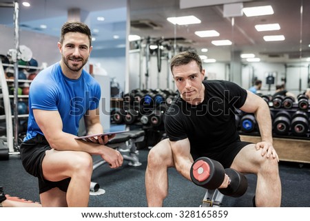 Fit man working out in weights room at the gym