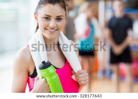 Fit woman smiling at camera at the gym