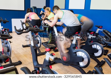 Fit people in a spin class at the gym