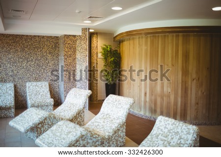 Multiple stone chairs in the sauna suite at the spa