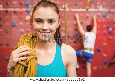 Fit woman at the rock climbing wall at the gym