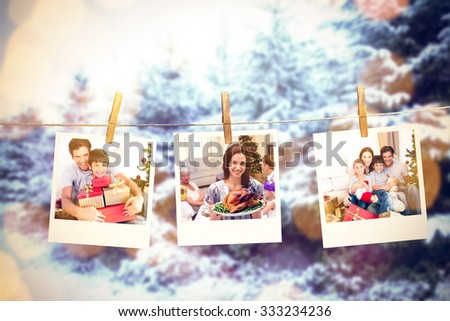 Happy father and son holding Christmas presents against snow covered forest against sky