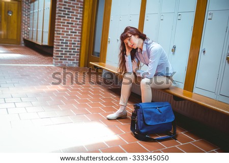 Mature student feeling stressed in hallway at the university
