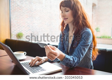 Student using laptop in cafe to shop online at the university