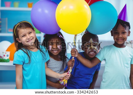 Happy kids with balloons at the birthday party