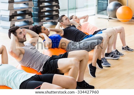 Fitness class exercising in the studio at the gym