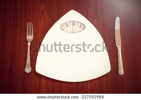 Weighing scale against overhead view of delicious chicken dish with salsa