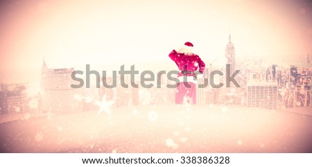 Santa scratching his head against new york skyline