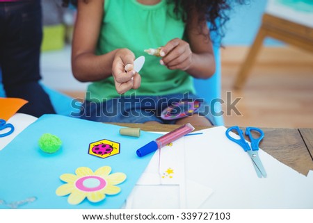 Happy kids doing arts and crafts together at their desk