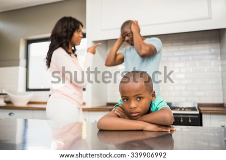 Parents arguing in front of son in the kitchen