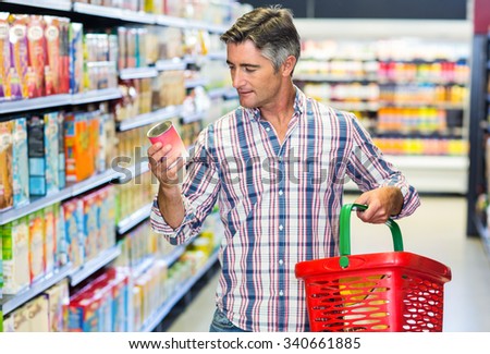 Man reading nutritional values at supermarket