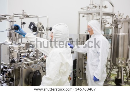 Scientists working with large vat in the lab