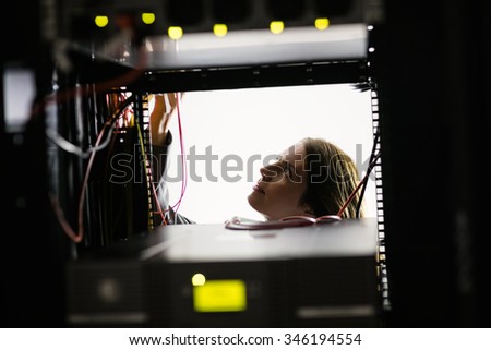 Technician working on the server at the data centre