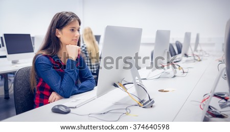 Serious student working on computer at university