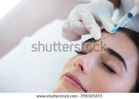 Woman receiving botox injection at spa