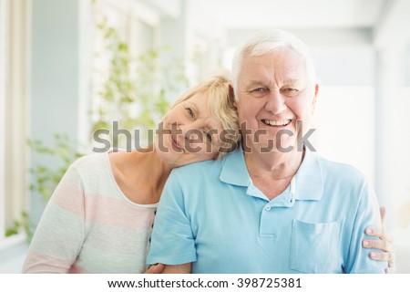 Portrait of happy senior couple smiling at home
