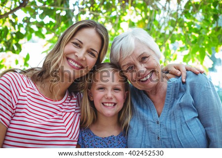 Portrait of happy family with granny standing outdoors