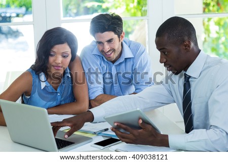 Couple and real estate agent discussing together at home