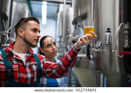 Brewers testing beer at brewery
