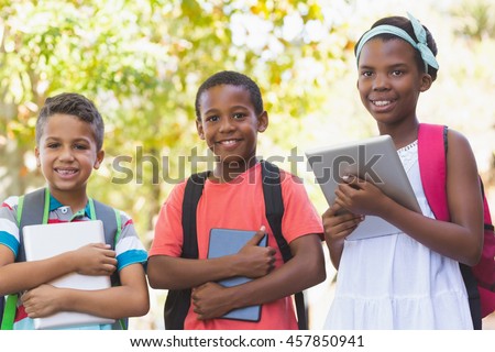 Portrait of school kids using digital tablet at school campus