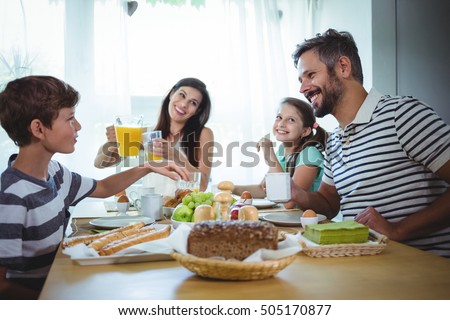 Happy family having breakfast at home