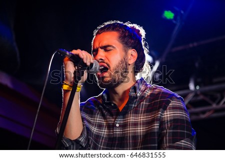 Close up of man singing on microphone in nightclub
