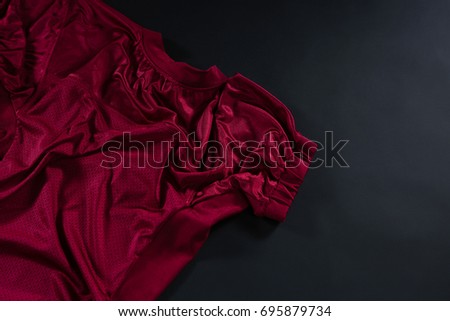 Close-up of American football jersey fabric against black background