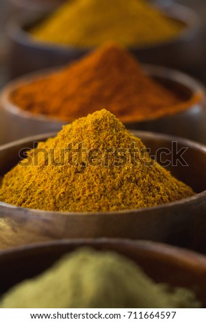 Close-up of various spice powder on wooden table